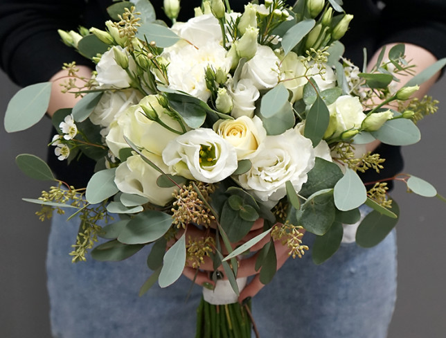 Bridal bouquet of white rose, eustoma, dianthus, eucalyptus and waxflower photo